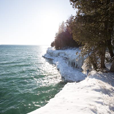Hike along the shore of Whitefish Dunes State Park