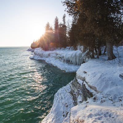 Hike along the shore of Whitefish Dunes State Park
