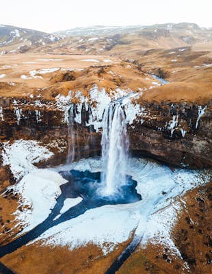 Walk under a waterfall in Iceland