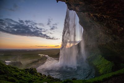 Walk under a waterfall in Iceland