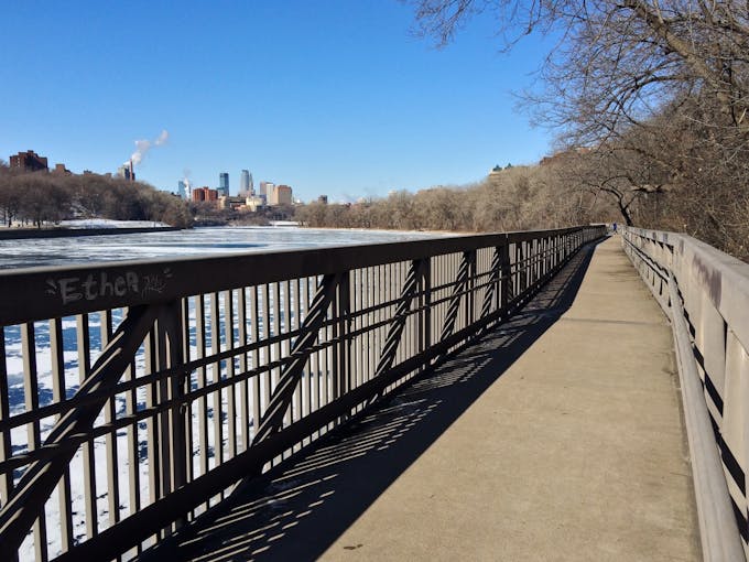 The walkway along the Mississippi River with the Minneapolis skyline in the background.