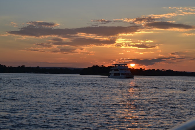large boat on river with sunsetting