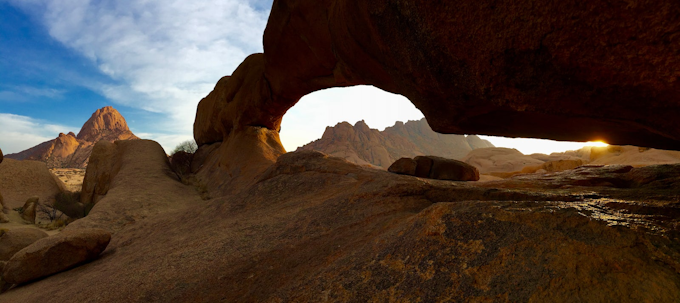 red rock arch with blue sky