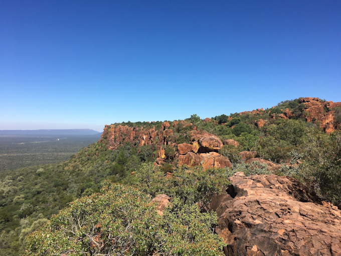 red table mountain with green bushes all over
