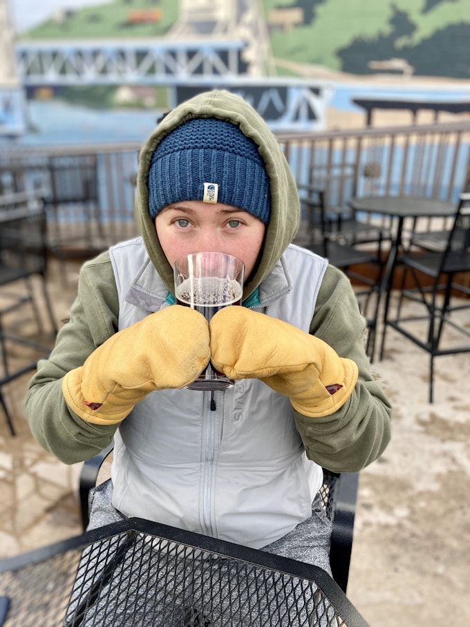 Erica sipping a cold beer in the cold up at Keweenaw Brewing Co in Houghton, Michigan