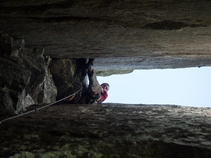A rock climber looks down the crack