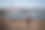 A person is hiking away from the camera toward the Chicago skyline.