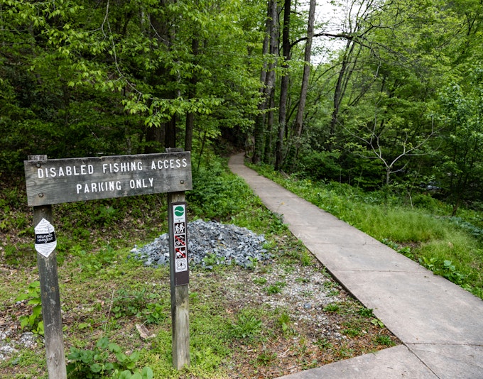 A wooden sign reads, 