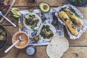 Smoky Mexican beef tacos and chili lime corn over the campfire