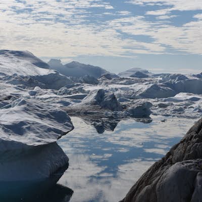 Hike the Ilulissat Icefjord by taking the Green Trail to Sermermiut then following the Blue Trail